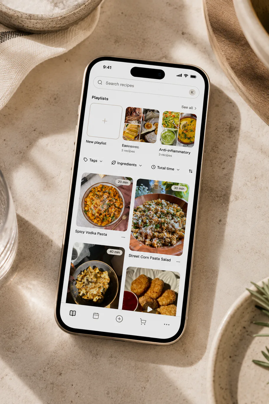 A phone showing a saved recipe vault in Belly with playlists, search, and filters